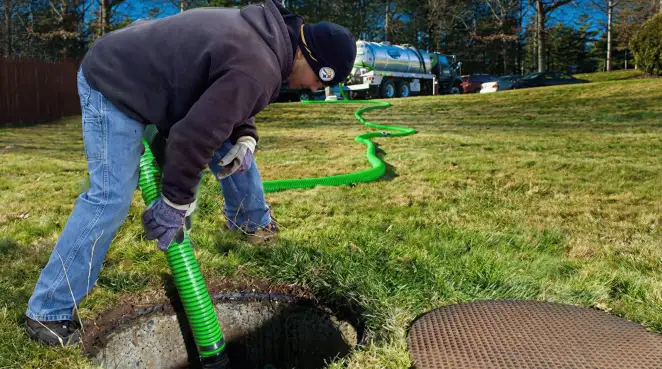 Service technician performing residential septic pumping and drainage maintenance in Jersey City, NJ